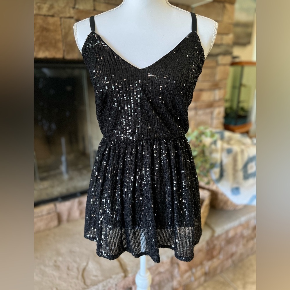Black sequin peplum top